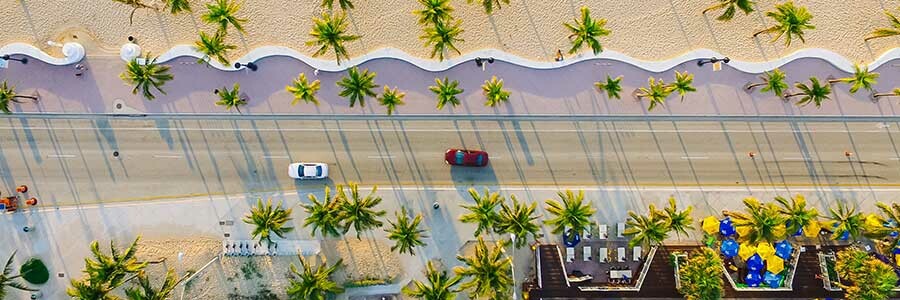Birds eye view of road running alongside a Miami beach