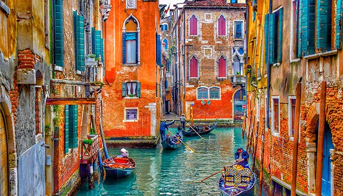 Beautiful picture of colourful buildings in a Venice Canal with gondolas